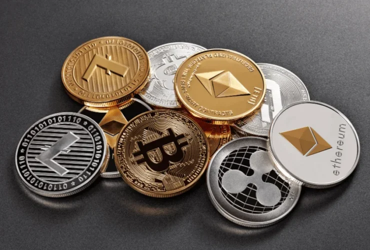 Various cryptocurrency coins, including Bitcoin and Ethereum, scattered on the ground. This image represents a comprehensive Guide to Cryptocurrency.