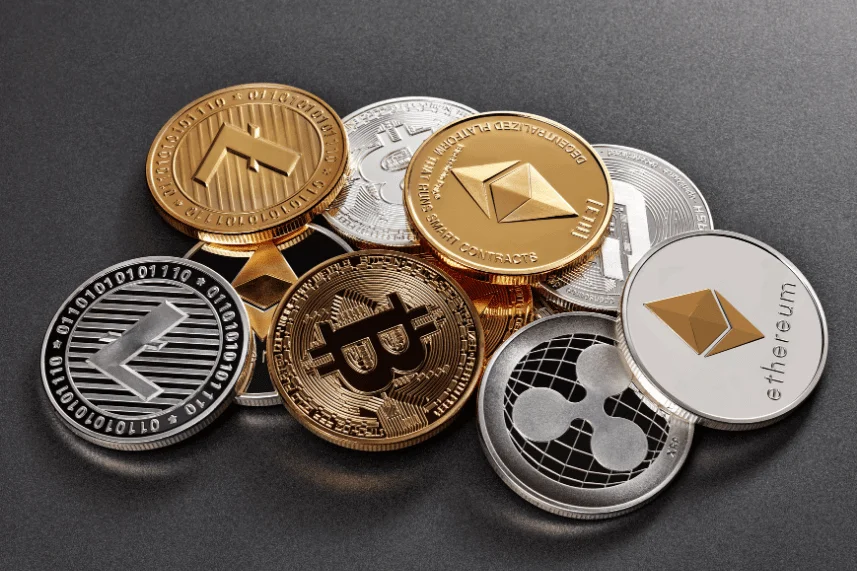 Various cryptocurrency coins, including Bitcoin and Ethereum, scattered on the ground. This image represents a comprehensive Guide to Cryptocurrency.