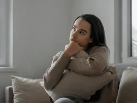 A girl sitting alone, looking thoughtful and sad at a networking event. This image represents the struggles introverts often encounter, highlighting the importance of Networking Tips for Introverts to help them engage more comfortably.