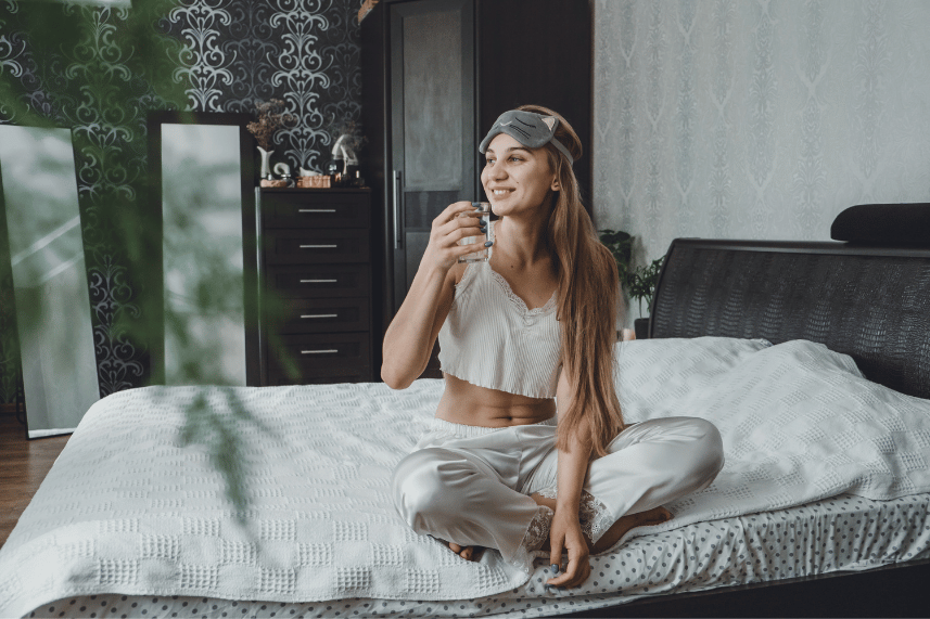 Relaxing self-care setup with candles, a book, and a cup of tea.