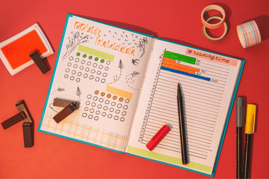 Open bullet journal with colorful pens and creative layouts.