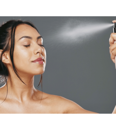 Woman refreshing her skin with Mario Badescu Facial Spray.