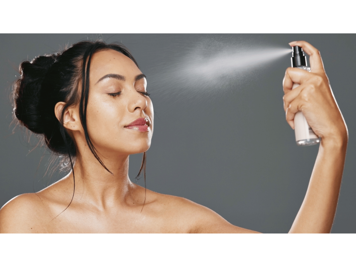 Woman refreshing her skin with Mario Badescu Facial Spray.