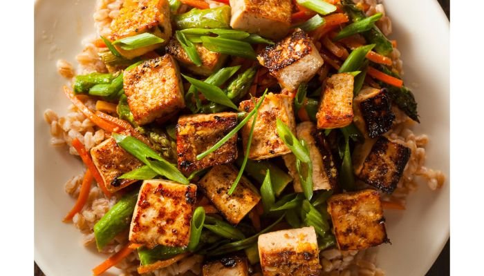 Crispy pan-seared tofu stir-fry with green beans, carrots and scallions over brown rice for a healthy weight loss meal