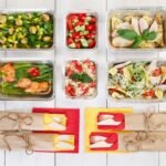 Healthy meal boxes for weight loss: six portioned meal prep containers with vegetables, lean protein and whole grains